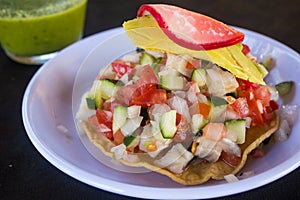 Fresh fish ceviche tostada served at a beach restaurant