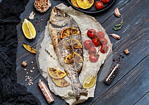 Fresh fish dorado. Raw dorado fish and ingredient for cooking. Fresh fish gilt-head bream dorade with salt, herbs and pepper.