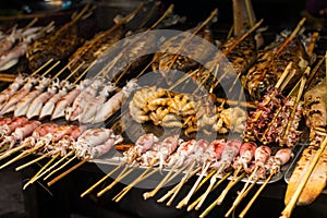 Fresh fish food on barbecue in a street market in Asia.