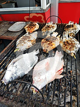 Fresh fish is grilled at the fish market