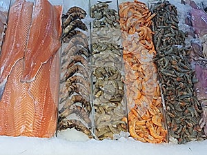 Fresh fish on ice, different types, colorful, whole and fillets, in a fishmonger .