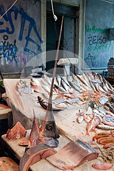 Fresh fish inclusing large swordfish head sold at a market in Sicily, Italy