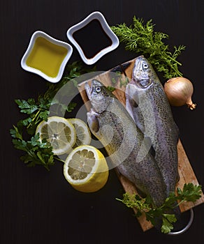 Fresh fish rainbow trout with greens