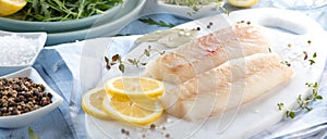 Fresh fish, raw cod fillets with addition of herbs and lemon.