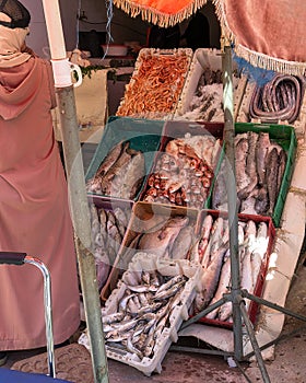 Fresh fish for sale in the Marrakesh Souk along one side of Jemaa el-Fnaa square and market place in Marrakesh`s medina quarter.