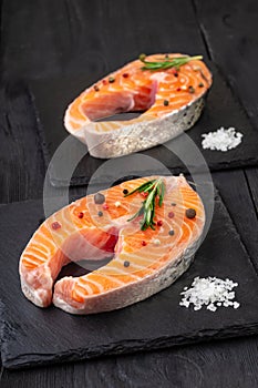 Fresh fish. Salmon steak on black board