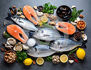 Fresh fish and seafood on grey table, flat lay.