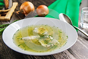 Fresh fish soup with ingredients and spices. Wooden background