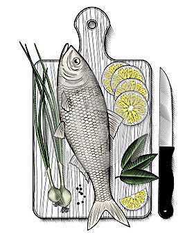 Fresh fish with spices, lemon, herbs and green onions on a wooden Board photo