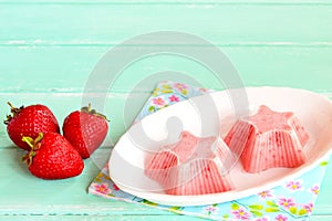 Fresh and flavorful strawberry ice cream on a plate. Frozen sweet strawberry yogurt shaped star