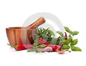 Fresh flavoring herbs and spices in wooden mortar