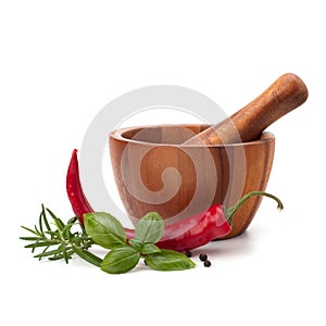 Fresh flavoring herbs and spices in wooden mortar photo