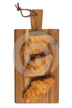 Fresh flavorous croissant on wooden table isolated on white