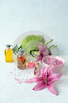 Fresh flower, burning candles, sea salt, oil and herbal tincture on the table