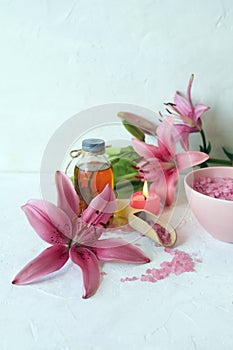 Fresh flower, burning candles, sea salt, oil and herbal tincture on the table