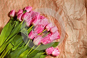 Fresh flower composition, bouquet pink tulips on craft paper background. Valentine, Women`s, 8 march, birthday, mother`s