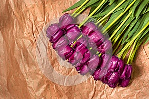 Fresh flower composition, bouquet purple tulips on craft paper background. Valentine, Women`s, 8 march, birthday, mother