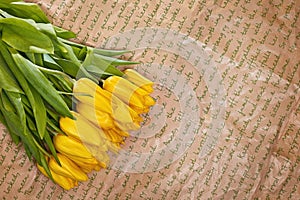 Fresh flower composition, bouquet yellow tulips on craft paper background. Valentine, Women`s, 8 march, birthday, mother
