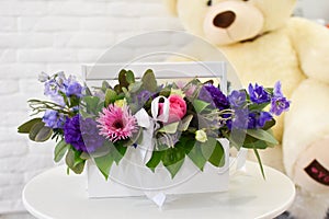 Fresh flowers in box, beautiful flower arrangement on table.