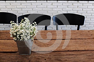 Fresh flowers in flowerpot on wood table