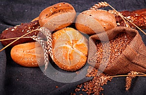 Fresh fragrant bread on the table. Food concept. Bakery, crusty loaves of bread and buns. Assortment of baked bread