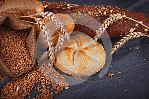 Fresh fragrant bread on the table. Food concept. Bakery, crusty loaves of bread and buns. Assortment of baked bread