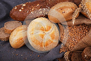 Fresh fragrant bread on the table. Food concept. Bakery, crusty loaves of bread and buns. Assortment of baked bread