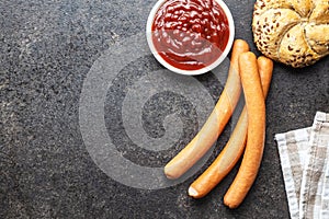 Fresh frankfurter sausages with bun and ketchup