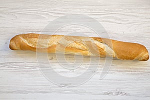 Fresh french baguette on white wooden background,