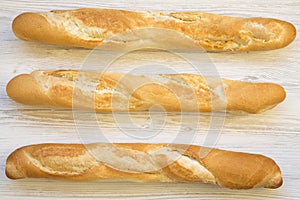Fresh french baguettes on white wooden background