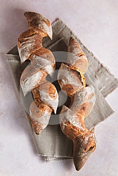 Fresh French Epi bread on the vintage background with linen tablecloth.