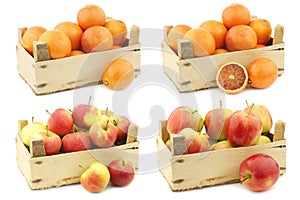 Fresh fresh `Sissi red` apples, red and yellow apples  and blood oranges in a wooden crate