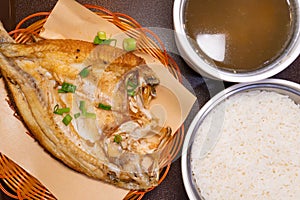 fresh fried sea bass and rice and soup of stewed tender chicken with ginseng at horizontal composition