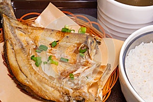 fresh fried sea bass and rice and soup of stewed tender chicken with ginseng at horizontal composition