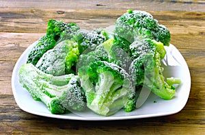 Fresh frozen broccoli on white plate