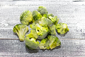 Fresh frozen broccoli on a wooden background, healthy diet, close-up