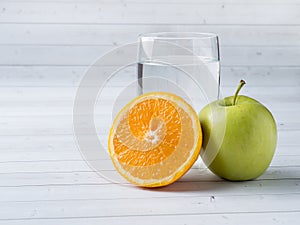 Fresh fruit Apple orange Cup of water on the table Diet