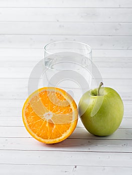 Fresh fruit Apple orange Cup of water on the table Diet