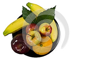 Fresh fruit on a black tray with bananas, apples and navel oranges