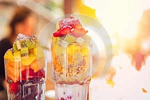 Fresh fruit cocktail finely chopped orange slices, strawberries, kiwi, yogurt, oatmeal. Concept health is refreshing and