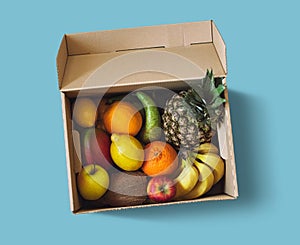 Fresh fruit delivery box on blue background