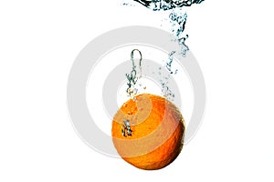 Fresh fruit dives into cold water with splash