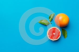 fresh Fruit grapefruit with Juicy grapefruit slices on colored background. Top view. Copy Space. creative summer concept