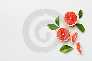 fresh Fruit grapefruit with Juicy grapefruit slices on colored background. Top view. Copy Space. creative summer concept