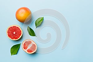 fresh Fruit grapefruit with Juicy grapefruit slices on colored background. Top view. Copy Space. creative summer concept