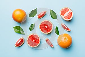 fresh Fruit grapefruit with Juicy grapefruit slices on colored background. Top view. Copy Space. creative summer concept