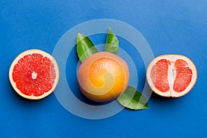 fresh Fruit grapefruit with Juicy grapefruit slices on colored background. Top view. Copy Space. creative summer concept