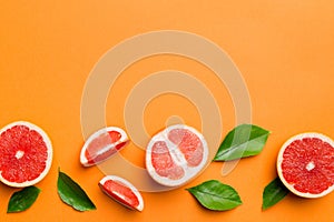 fresh Fruit grapefruit with Juicy grapefruit slices on colored background. Top view. Copy Space. creative summer concept