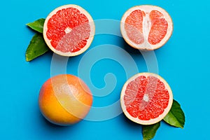 fresh Fruit grapefruit with Juicy grapefruit slices on colored background. Top view. Copy Space. creative summer concept