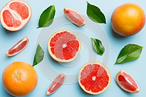 fresh Fruit grapefruit with Juicy grapefruit slices on colored background. Top view. Copy Space. creative summer concept